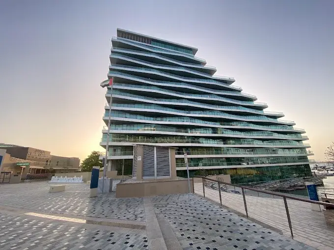 Al Hadeel by Aldar exterior view of waterfront residential buildings at Al Raha Beach